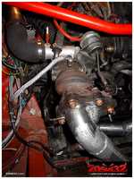 The turbocharger connected to the engine's coolant system.